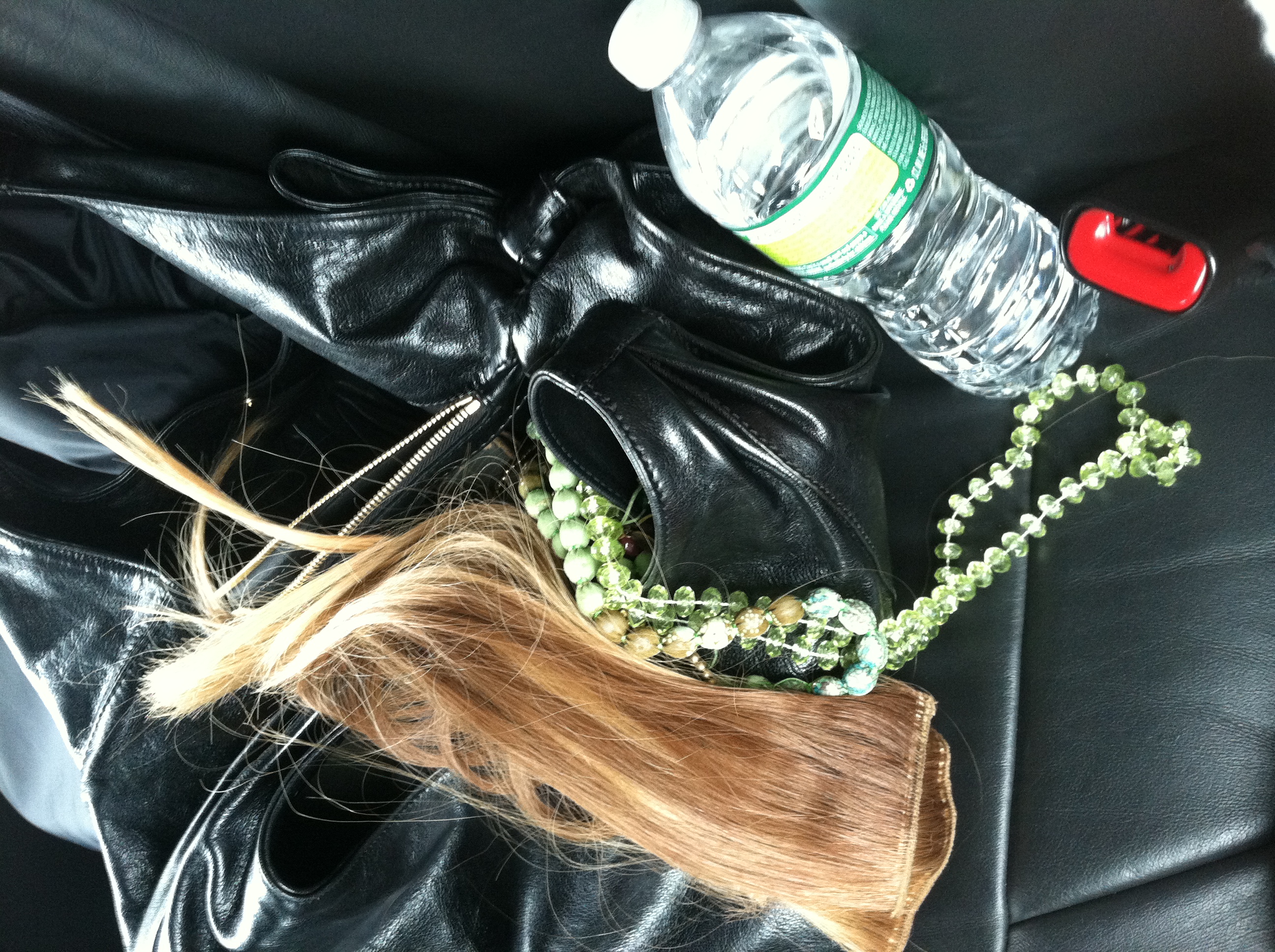 Extra hair and jewels bunched up on the backseat of a car... like a teenagers jeans.