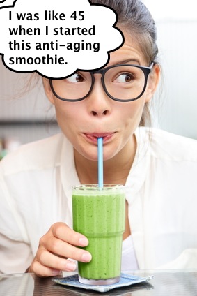 Green vegetable smoothie juice - woman drinking